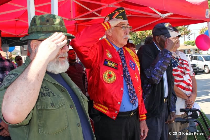 Veterans salute during the National Anthem